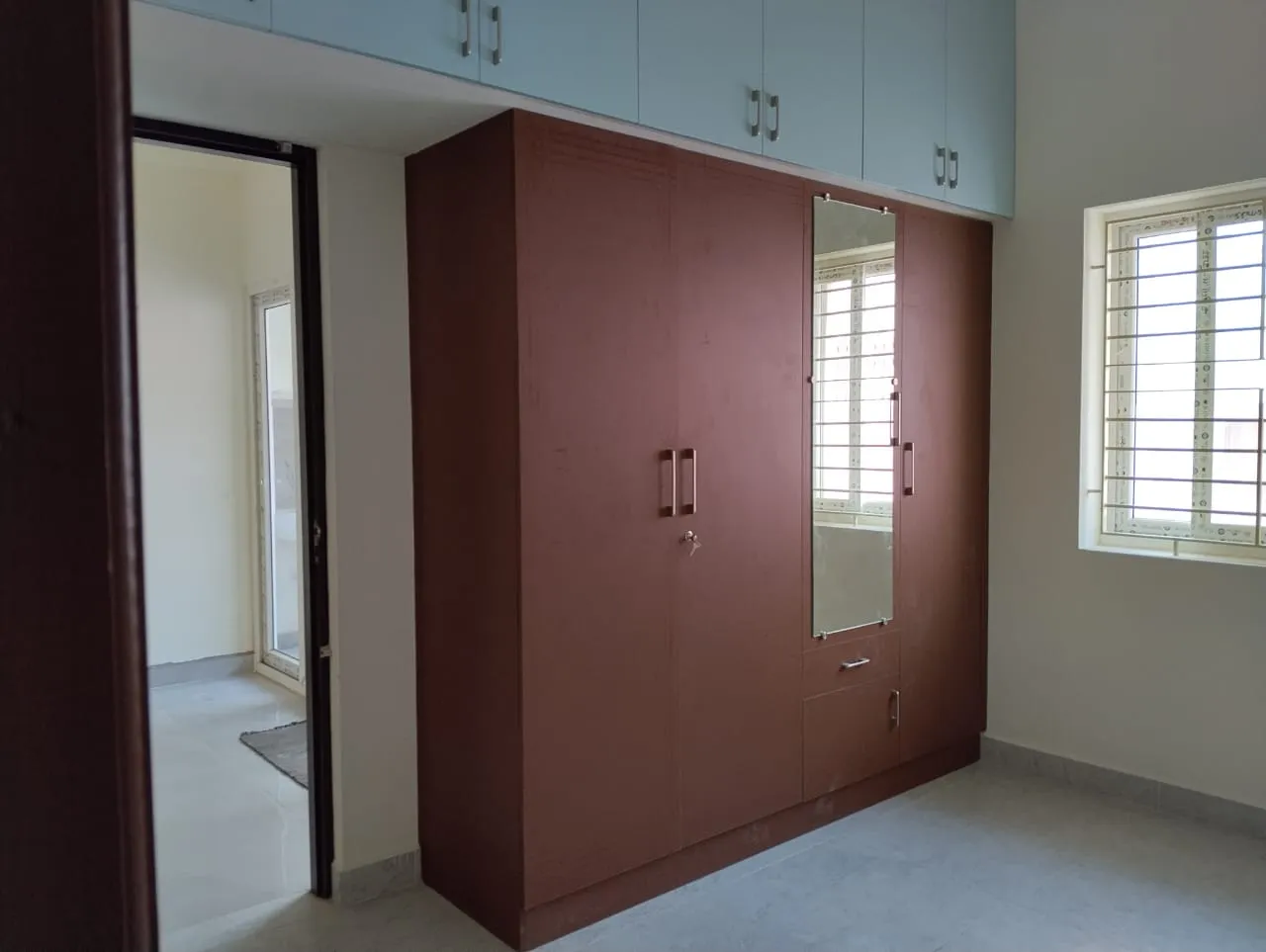 Four-Door Matte Brown Wardrobe with Integrated Pastel Blue Loft Storage Hinged Wardrobes Desk and Decor 