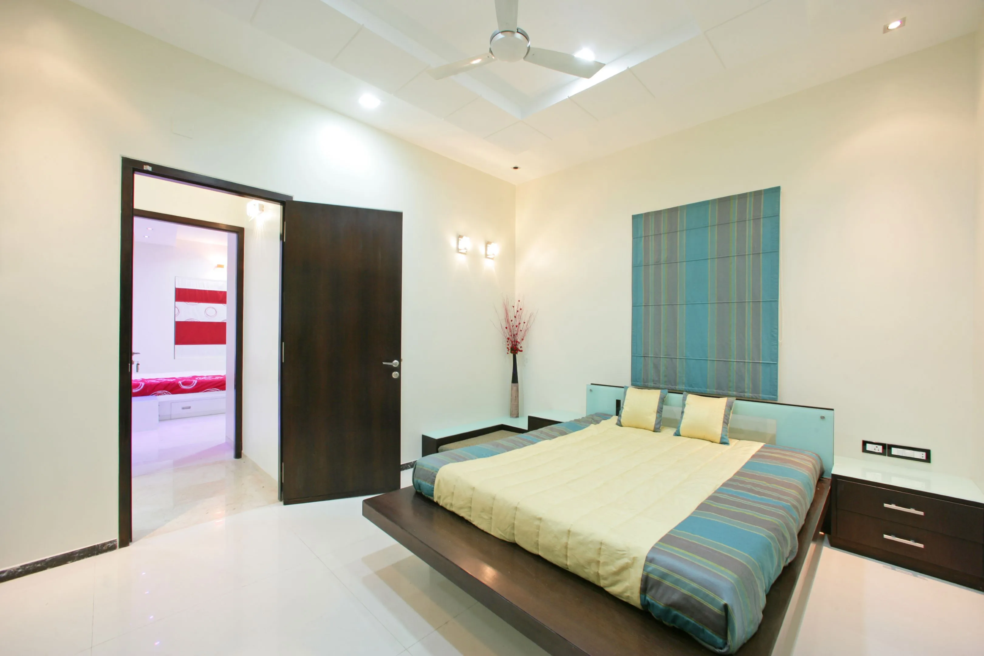 Contemporary Bedroom with Textured Grey Headboard & Red Accent Wall Modern Bedroom Desk and Decor 