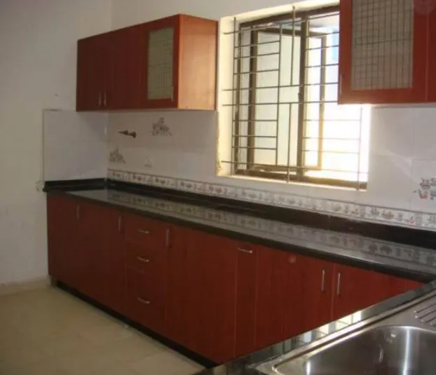 L-Shaped Modular Kitchen with Wood Grain Finish & Circular Accent Design Modular Kitchen Desk and Decor 