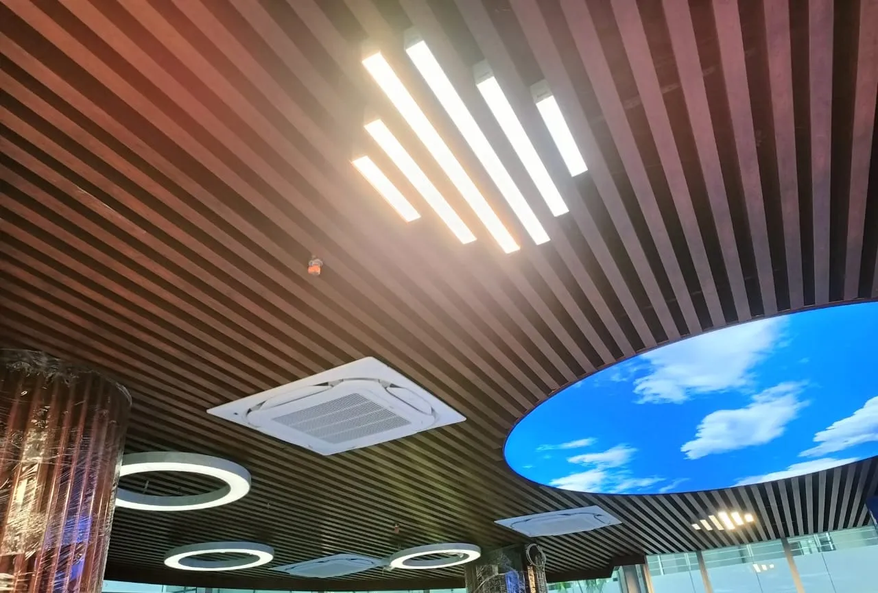 Wood-Finish Grid False Ceiling with Integrated Services – Corridor Architectural False Ceiling & Lighting Desk and Decor 