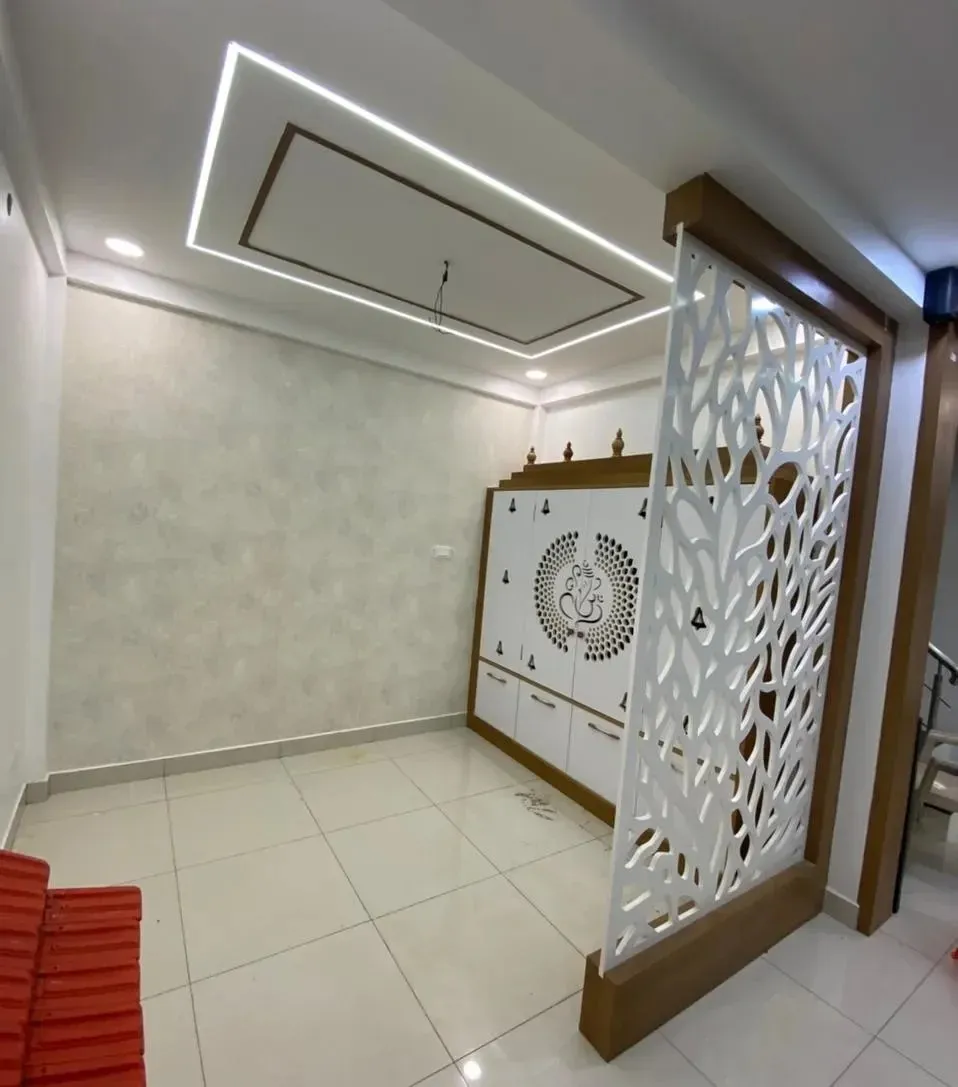 White Jaali-Cut Pooja Unit with Decorative Partition Screen with Dedicated Pooja Room at Deskanddecor