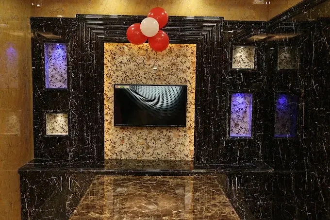 Reception Lobby / Elevator Foyer — Marble Feature Wall with TV Unit Focused Design at Deskanddecor