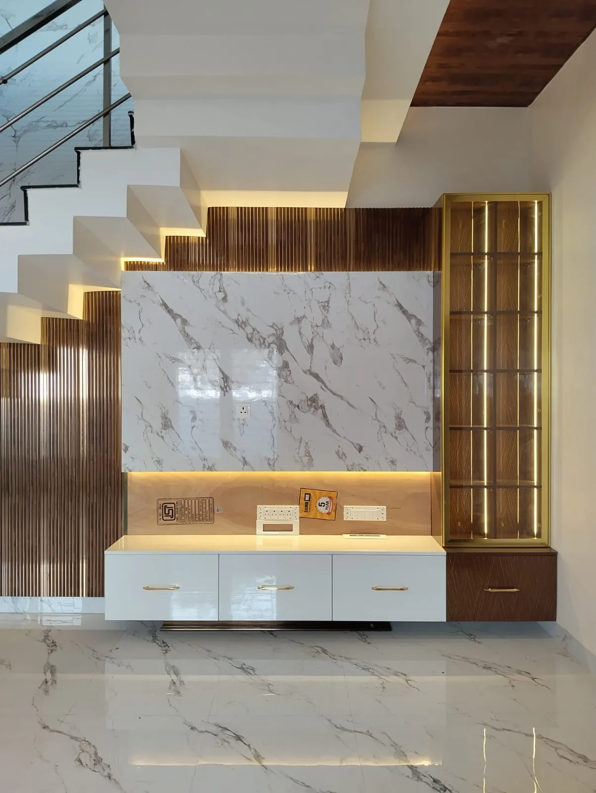 Under-Stair Entertainment Console with Backlit Marble and Fluted Accent Panels with Floor Standing TV Units at Deskanddecor
