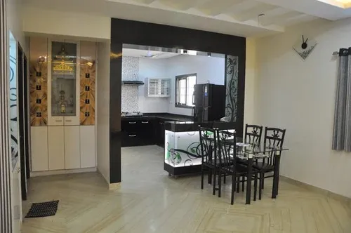 Open-Plan Kitchen with Dining Area & Pooja Unit Corner with Modern Dining Room Designs at Deskanddecor