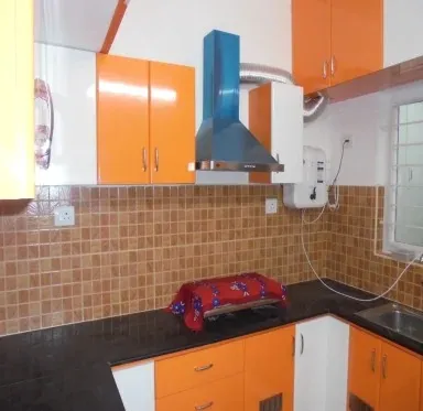 Vibrant Orange Modular Kitchen with Modular Kitchen at Deskanddecor