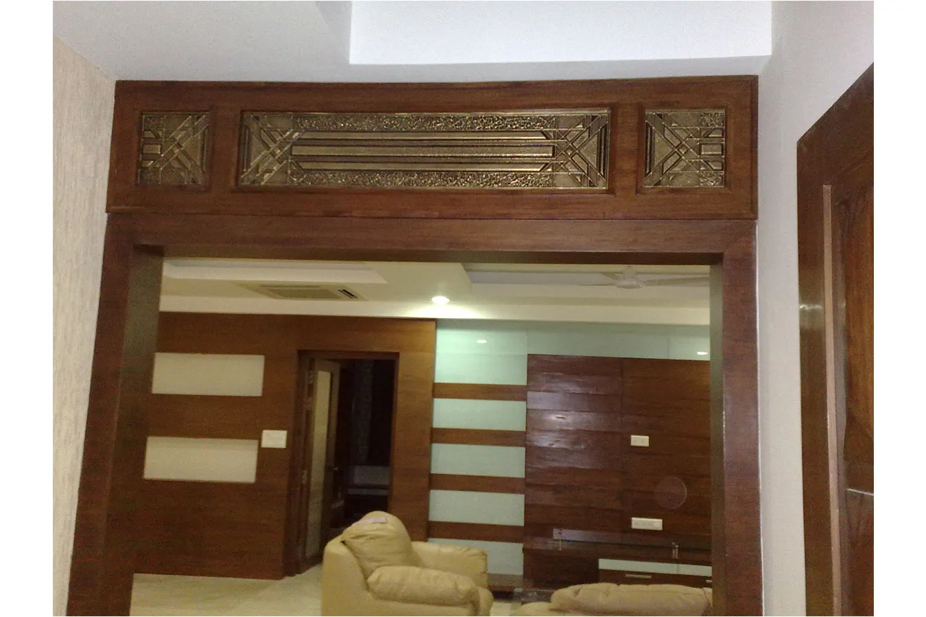 Living Room with Carved Wooden Entrance Frame with Wooden Carving Style Interiors at Deskanddecor