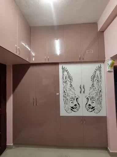Custom Floor-to-Ceiling Wardrobe with CNC Jali Design with Modular Wardrobe at Deskanddecor