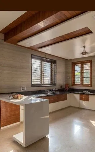 U-Shaped Modular Kitchen with Wooden Ceiling Beams & Breakfast Island with Modular Kitchen at Deskanddecor
