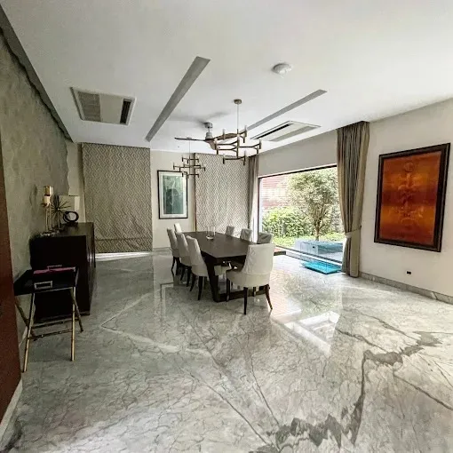 Open-Plan Dining Area with Garden View & Marble Flooring with Modern Living Room Designs at Deskanddecor