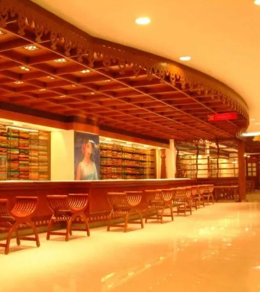Traditional Wooden False Ceiling with Display Counter – Saree Showroom Interior with Saree/Textile Showroom Display Unit at Deskanddecor