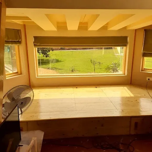 Raised Wooden Platform Seating with Coffered Ceiling & Bay Window with Wall Paneling at Deskanddecor